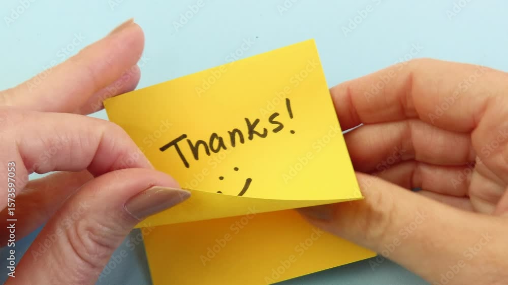 Video of woman hands preparing to stick a note with the handwritten expression 