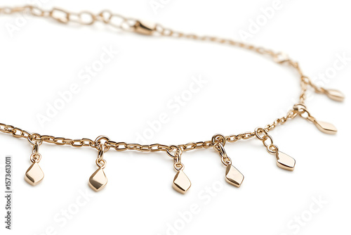 Wallpaper Mural Delicate golden anklet showcases minimalist charm with dangling diamond shaped pendants, ideal for jewelry design assets, fashion accessories, and elegant style. Torontodigital.ca