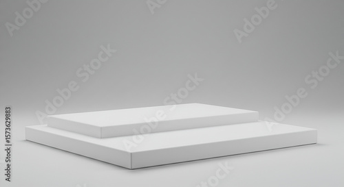 Minimalist two-tiered white platform on a simple grey background for presentations