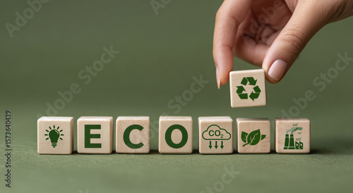 Wooden blocks with eco symbols on green background, promoting sustainability and eco friendly concepts