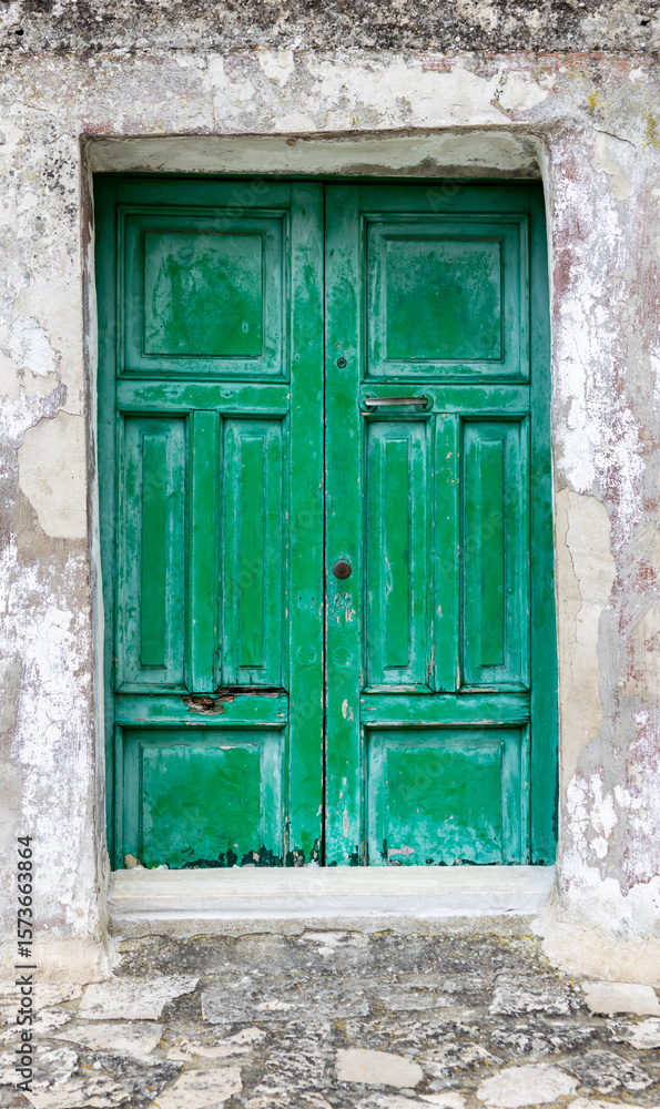 Fototapeta premium Old, worn, green-painted wooden doors. Architectural element.