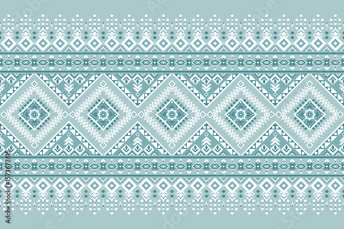 Seamless ethnic geometric pattern in teal and white, perfect for textile design, crafts, digital prints, and cultural decorative projects.