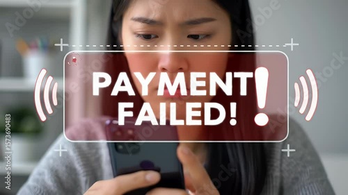 Worried Asian Woman Experiencing Payment Failure with Smartphone in a Bright Room With Red Alert Graphic Displaying Payment Failed Message