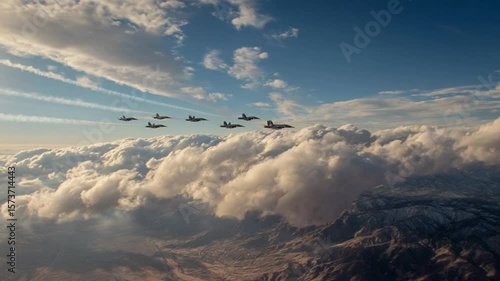 Aerial view of fighter jets flying in formation over clouds and mountains, dynamic military