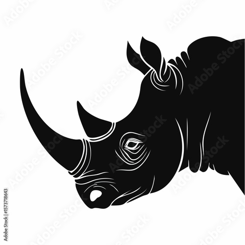 Silhouette of a rhinoceros' head, captured from the side, with its large horn, strong face, and tough skin texture, showcasi
