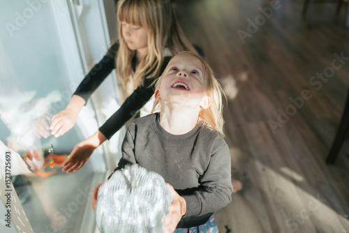 Two little girls decorating for halloween party at home