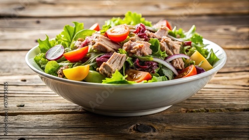 Wallpaper Mural A fresh tuna salad served in a white bowl with mixed greens on a wooden table Torontodigital.ca