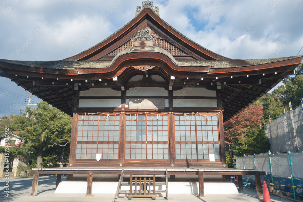 Naklejka premium Uji Shrine at Uji, Kyoto, Japan, Traditional Japanese temple architecture under a cloudy sky.