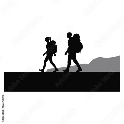 Couple hiking together with backpacks enjoying the mountain landscape silhouette