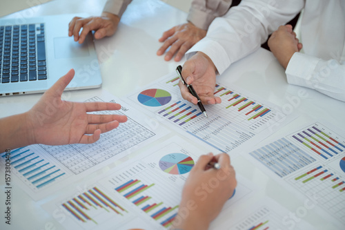 Businesspeople evaluate project efficiency and financial figures with business team for marketing research and business strategy plan.