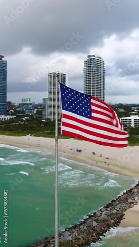 Wallpaper Mural American flag waving over a beach scene with high-rise buildings Torontodigital.ca