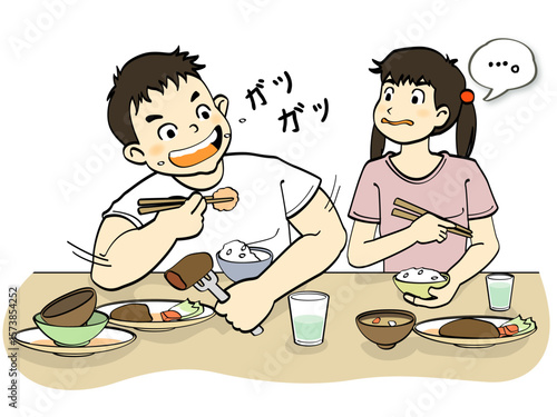 給食のご飯をガツガツ食べる大食いな男の子
