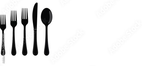 A symmetrical arrangement of black and white cutlery consisting of forks spoons and knives on a reflective surface