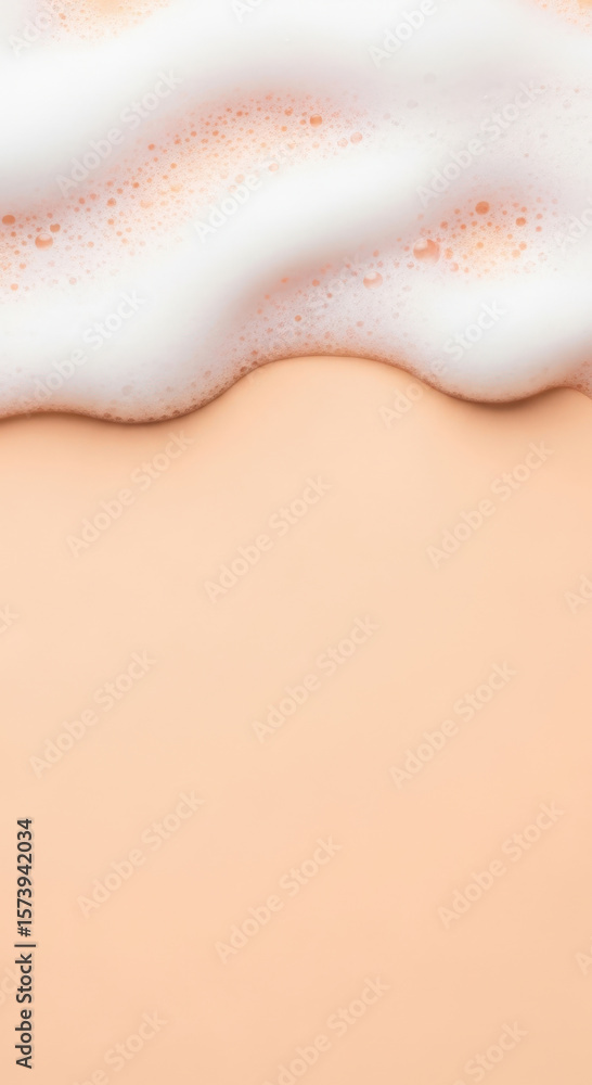 Fototapeta premium Soft white foam on pastel peach background creates soothing visual