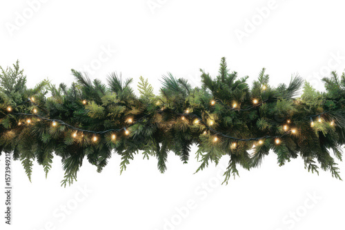 A christmas garland with green pine branches and warm glowing string lights