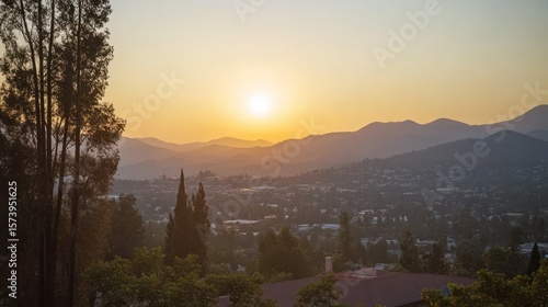 Sunset over hazy mountain city vista