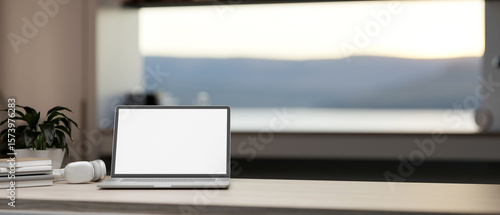 Wallpaper Mural White screen laptop with books and headphones on wooden table in a room with scenery outside window. Torontodigital.ca