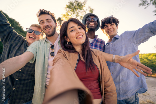 Принти на полотні A happy young woman taking a selfie with her diverse friends outdoors