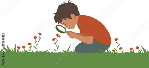 Curious young boy discovers nature's wonders with a magnifying glass in grassy field