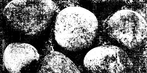 Black and white grunge texture of overlapping pebbles on a beach background