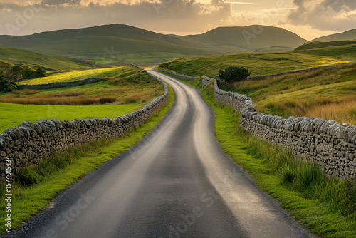 Winding Country Road with Stone Walls at Sunset. Picturesque countryside road flanked by stone walls, stretching into rolling green hills under warm evening light.