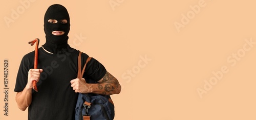 Male thief with crowbar and...
