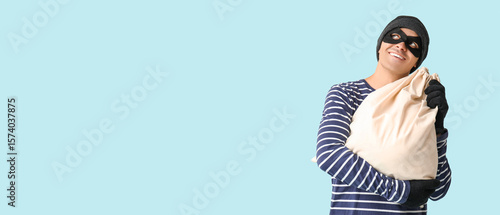 Male thief with bag on blue...