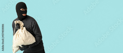 Male thief with bag on blue...
