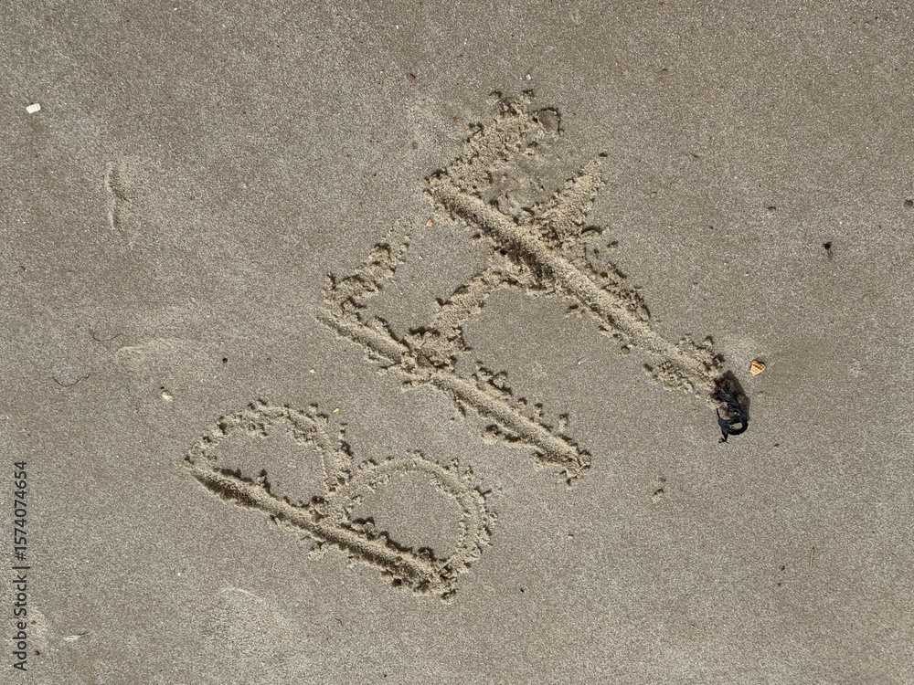 Obraz premium A childs hand has written BFF (best friends forever) in the sand on the beach of the North Sea coast