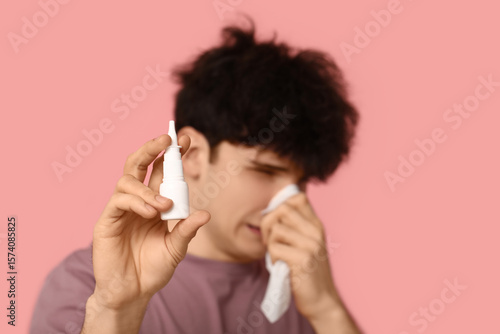 Young man with nasal drops ...
