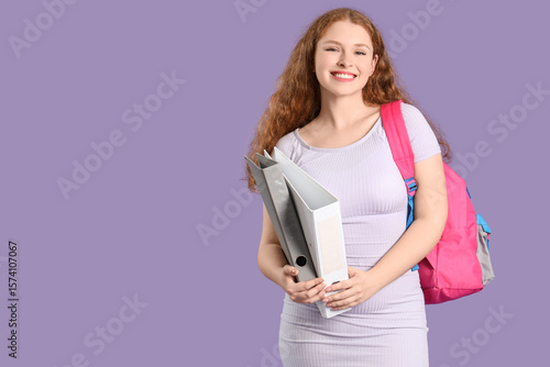 Happy female student with b...