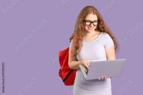 Happy female student with b...