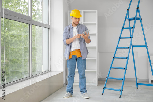 Male contractor working wit...