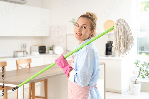 Mature woman with floor mop...