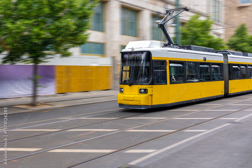 Naklejka premium Yellow tram in motion. Public transport. Urban mobility concept