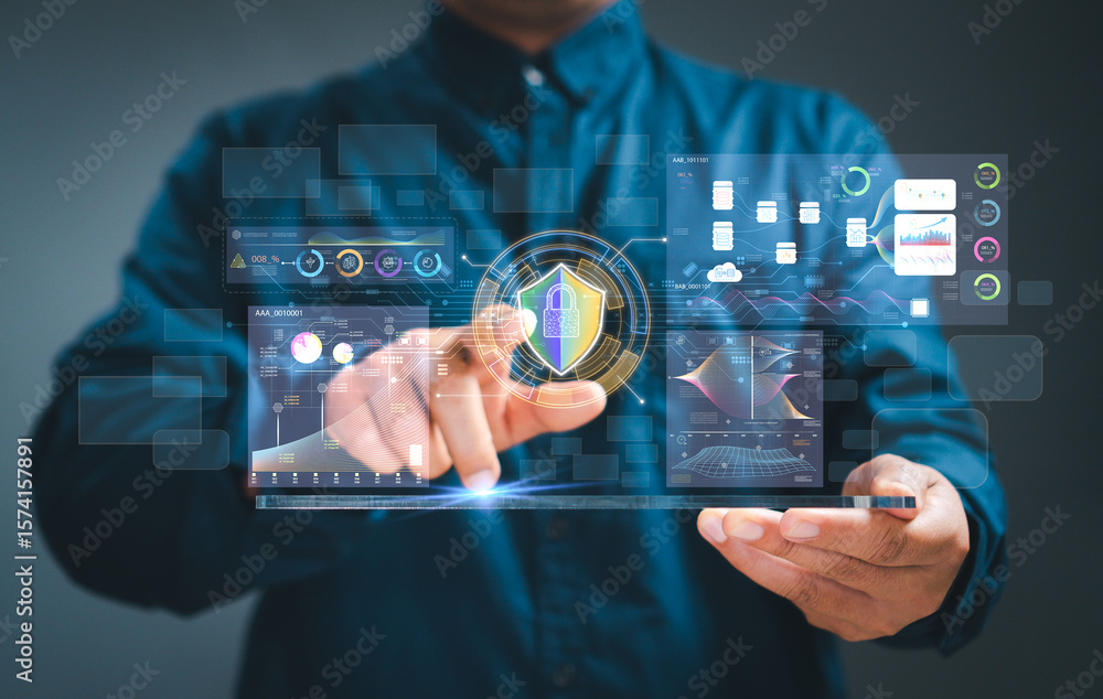 Obraz premium Concept Data Protection Cyber security. Businessman's hand Lock and shield icon work on virtual screen and dashboard for data business analysis data graphs,display at a modern workspace.