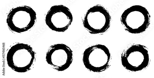 Set of hand drawn circular brush strokes in black ink with grunge texture isolated on white background perfect for abstract art design and creative elements.