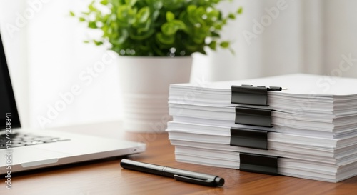 Essential items for office workflow including stacked documents securely fastened and writing tool