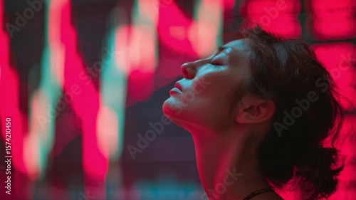 Radiant Contemplation: A woman closes her eyes, bathed in vibrant neon lights, capturing a moment of introspection and serenity.