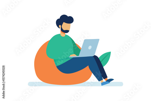Man with beard working on laptop while sitting on a bean bag chair