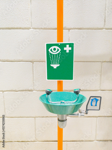 industrial emergency eyewash with battery, installed in a company for workers' safety.