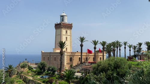 4K video Scenic view of Cap Spartel's lighthouse in front of the ocean surrounded by greenery on a sunny day - Tangier, Morocco
