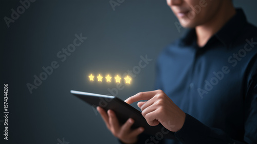 A person taps a tablet displaying five glowing stars, indicating a top customer rating or excellent online review, against a dark background.