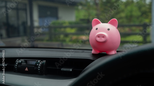 Canvastavla Pink piggy bank on car dashboard, symbolizing financial savings, car expenses, insurance planning, and budgeting for transportation or fuel costs