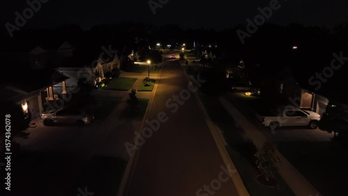 Wallpaper Mural Quiet American neighborhood with well-maintained front yards at night. Aerial Birds Eye shot. Luxury housewife parking cars on driveways. Sleepy and noble housing area in Florida. Torontodigital.ca
