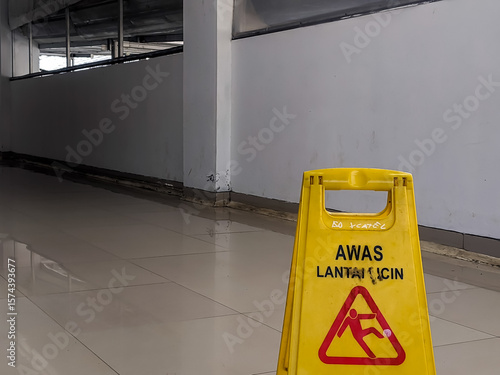 Yellow safety sign in Indonesian 