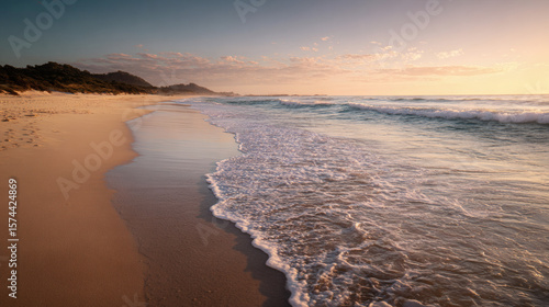 Wallpaper Mural The sun sets over a peaceful beach, casting a warm glow over the water and sand. Torontodigital.ca