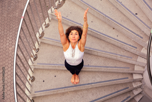Frau beim Yoga auf einer Treppe