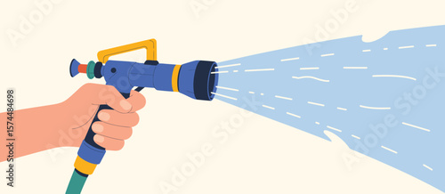 Hand holding a blue garden hose nozzle spraying a stream of water