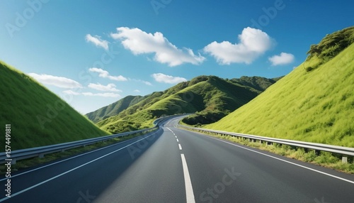 Scenic Winding Road Through Green Hills Under a Blue Sky